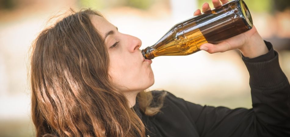 woman drinkin alcohol in bottle