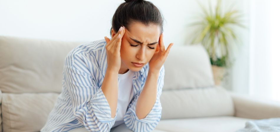 woman in addiction sitting on sofa